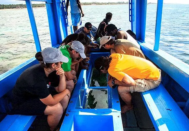 Glass-bottom boat cruising over coral reefs in Watamu Kenya